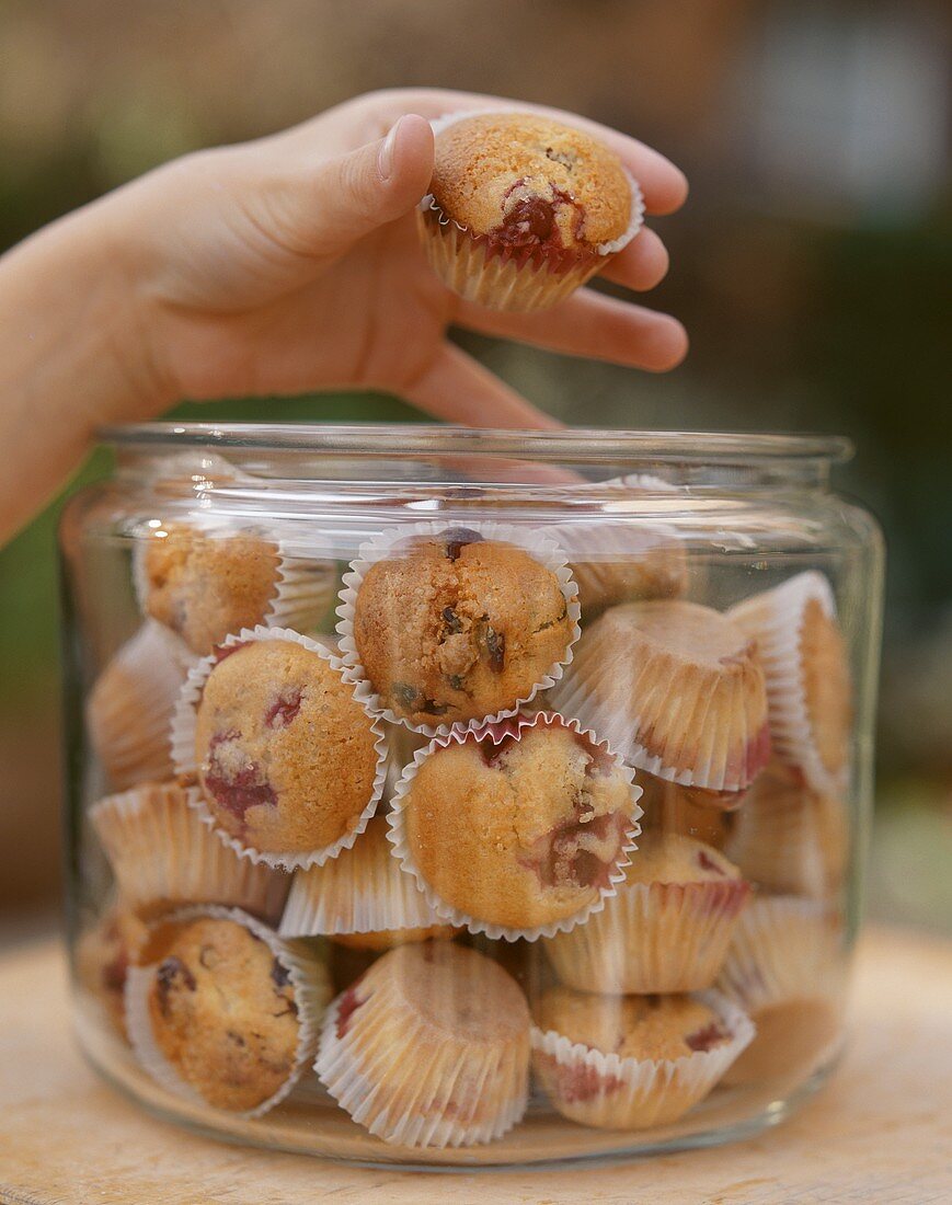 Lots of cherry muffins in a large jar