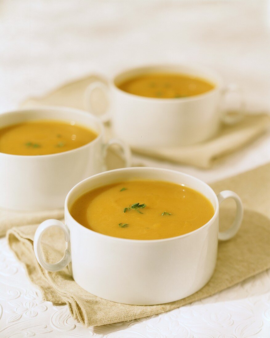 Pumpkin soup in white soup cups
