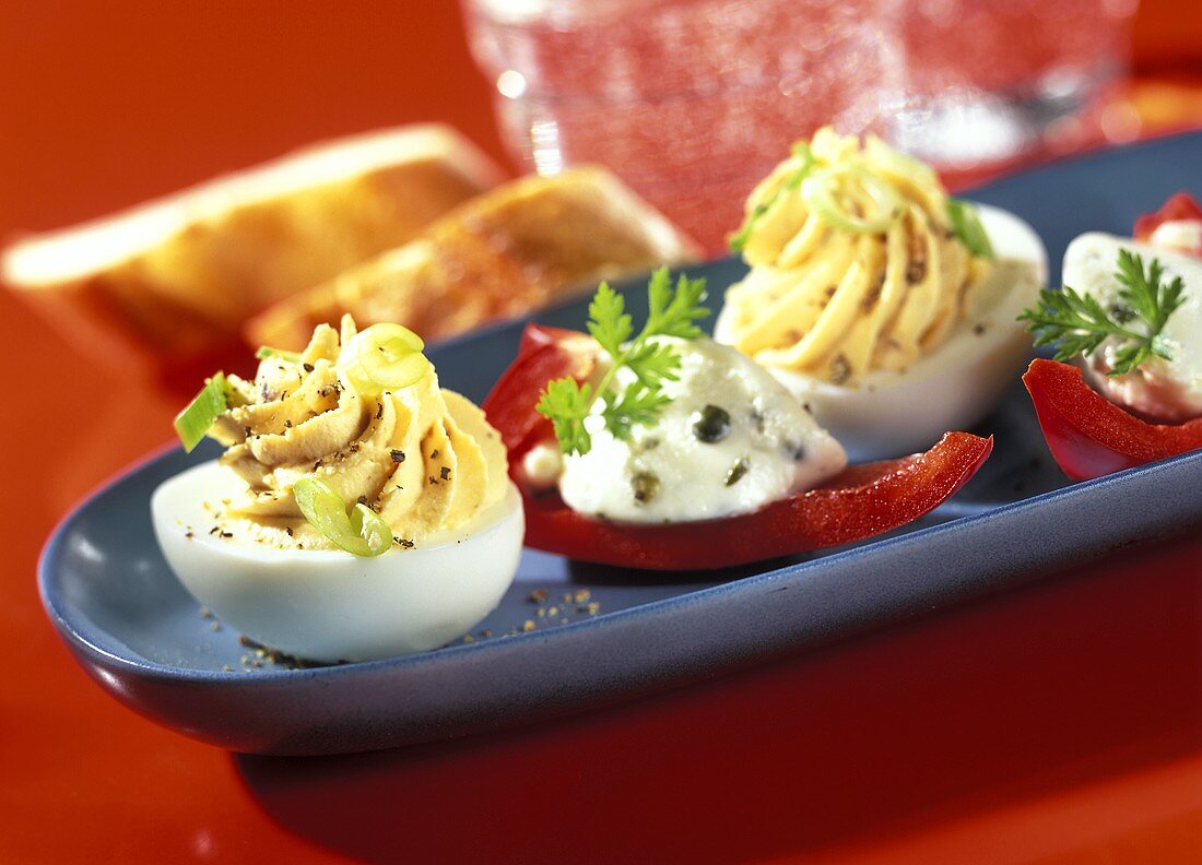 Stuffed eggs and pepper boats with cheese mousse