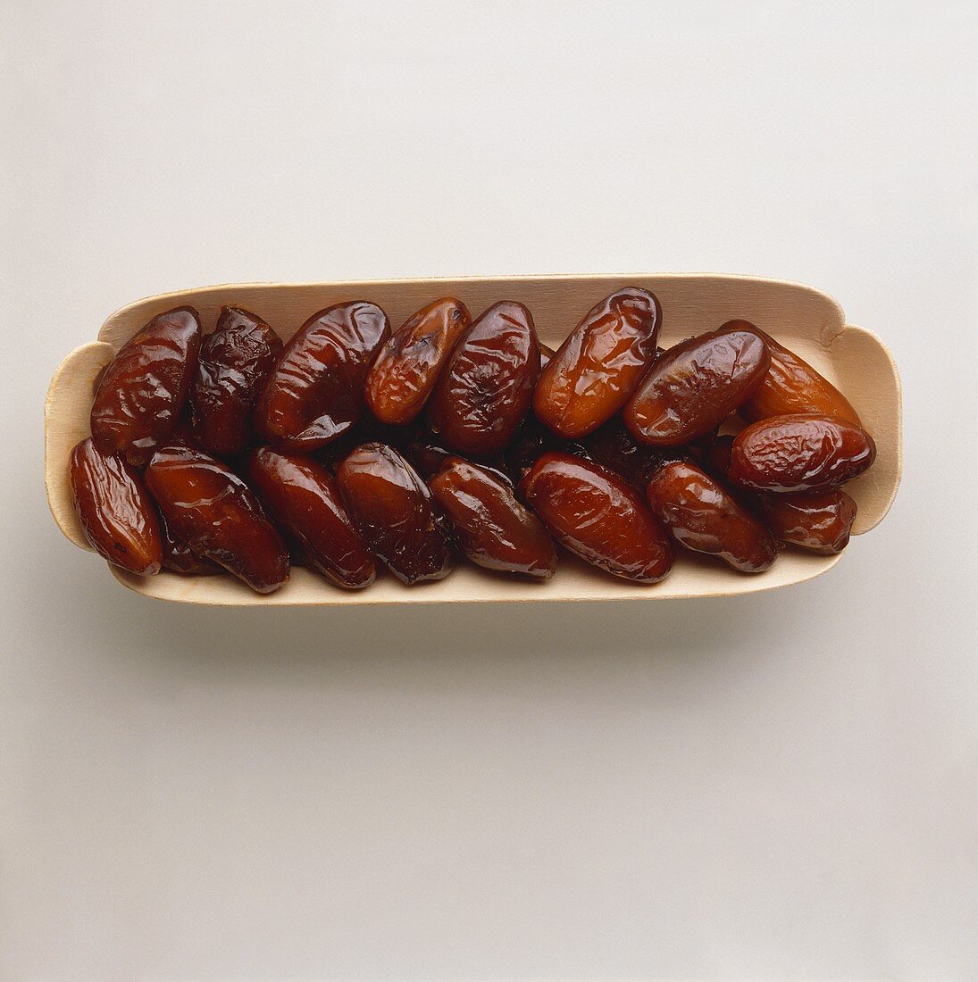 Dried dates in a cardboard punnet