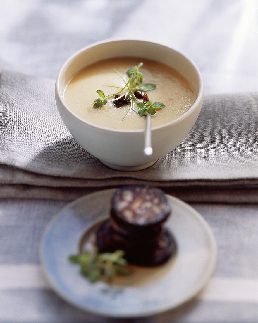 Potato soup with fried black pudding and prunes
