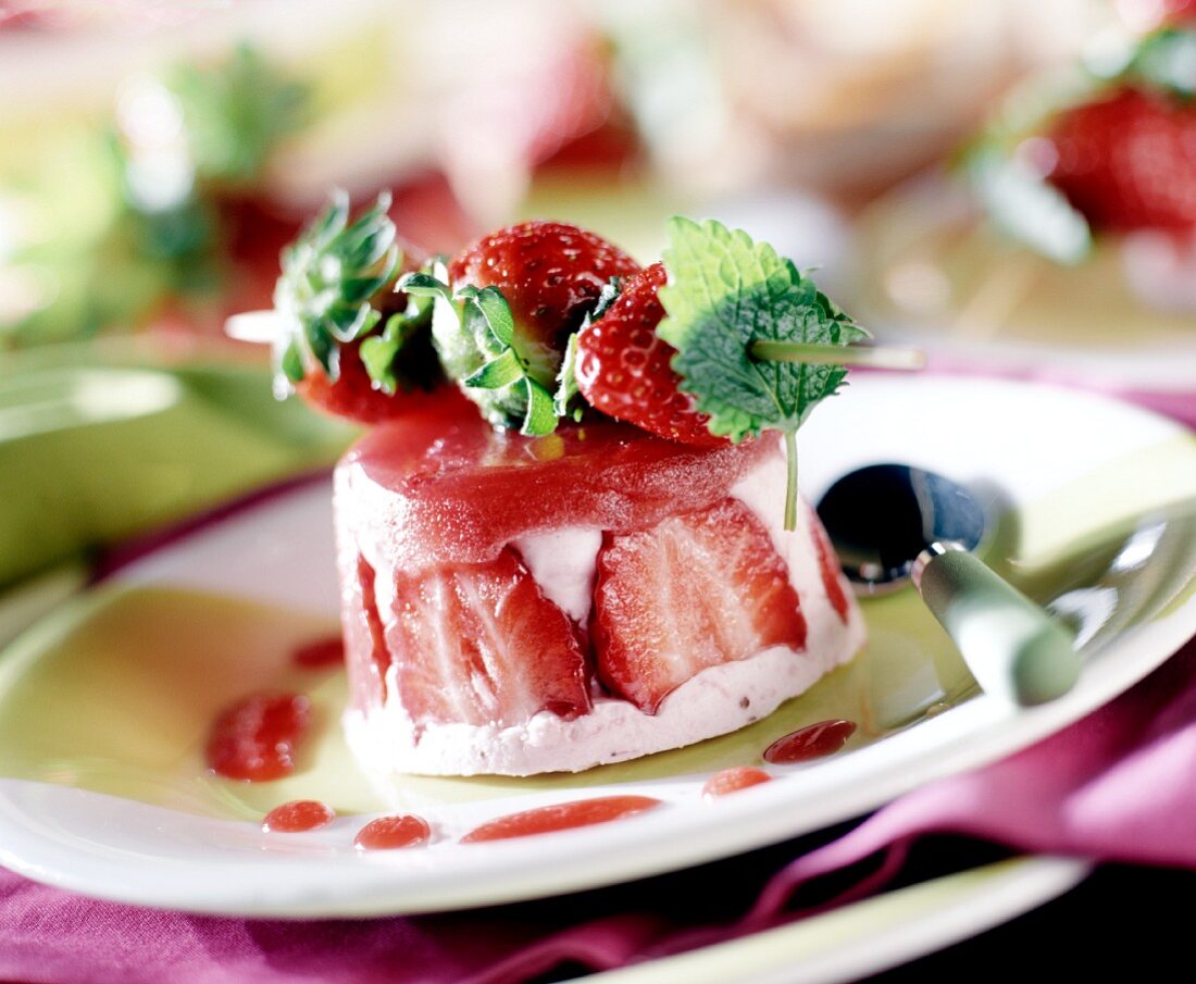 Strawberry mousse, with fresh strawberries on a skewer