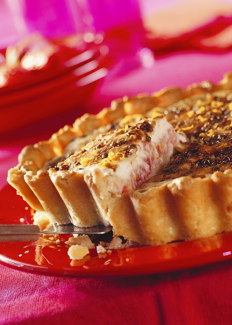 Strawberry and rhubarb tart on a red plate