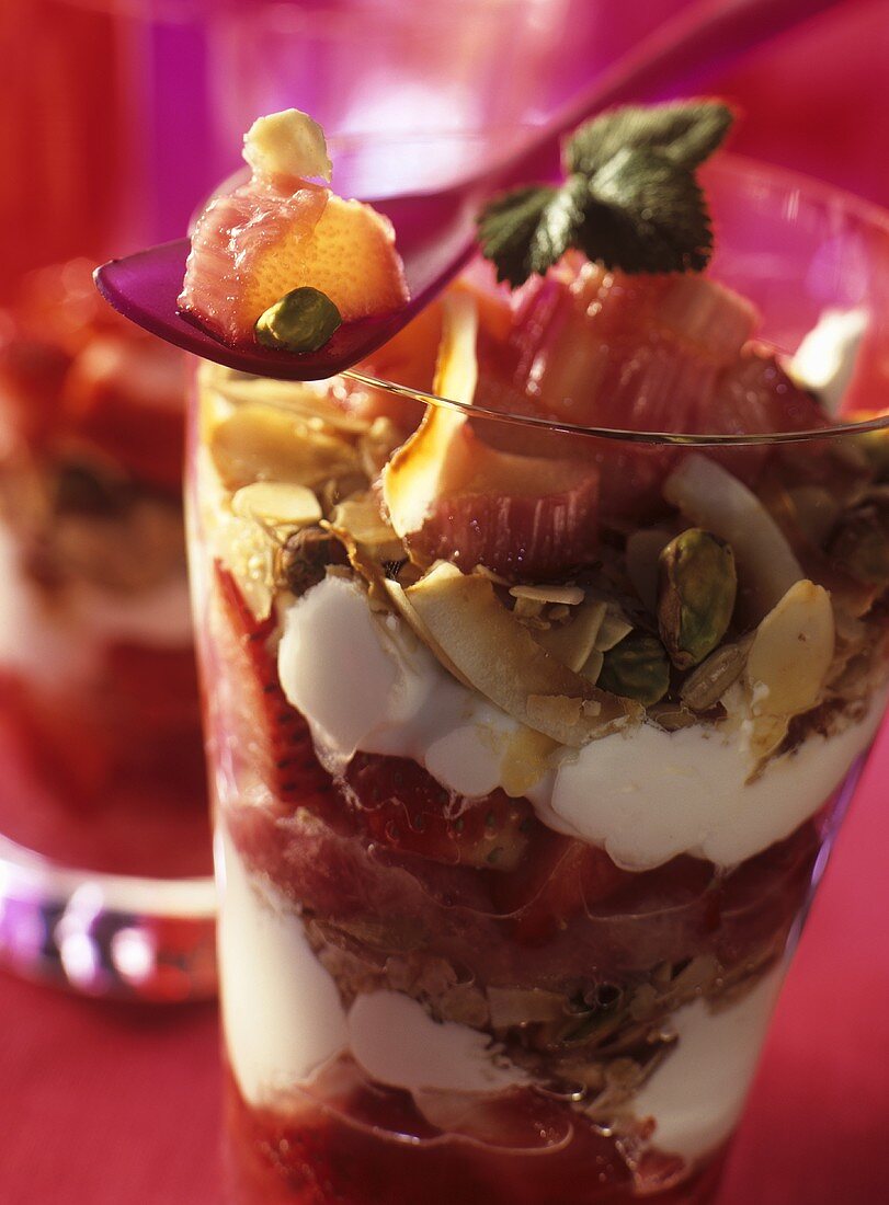 Parfait with strawberries, rhubarb and nuts in a glass