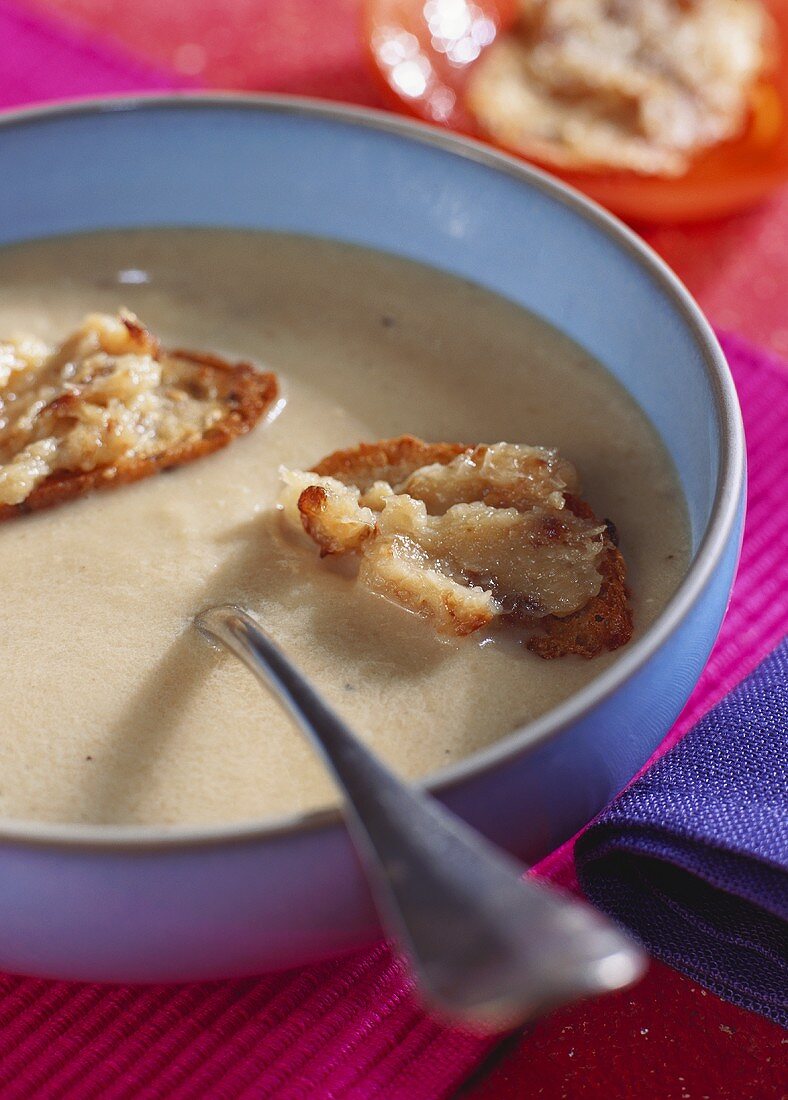 Cream soup with Camembert on toast