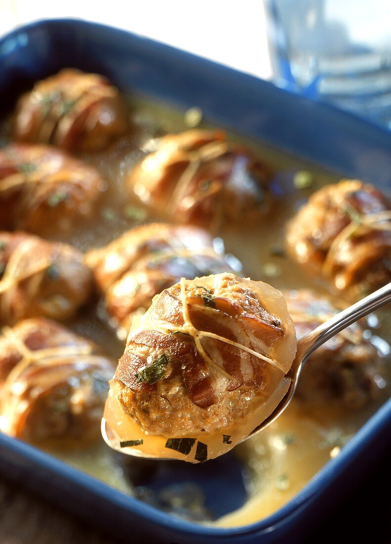 Meat dumplings with bacon in jelly in a roasting dish