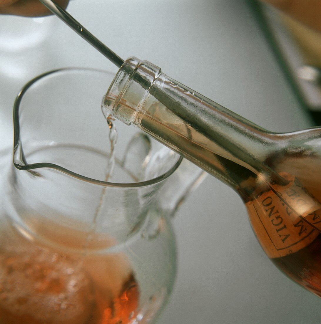 Decanting wine with cork remains into carafe