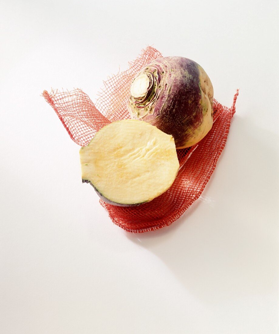 Whole and half turnip on a red net