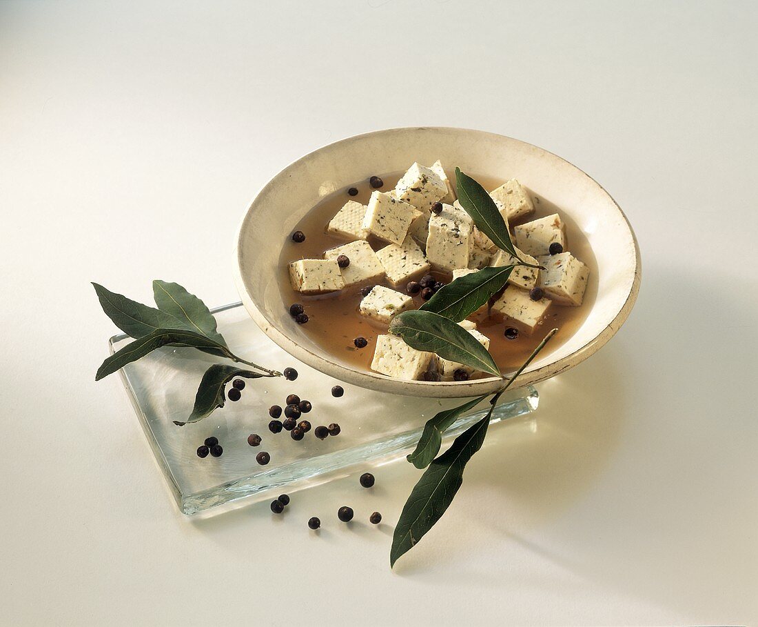 Tofu cube in marinade with peppercorns & bay leaf
