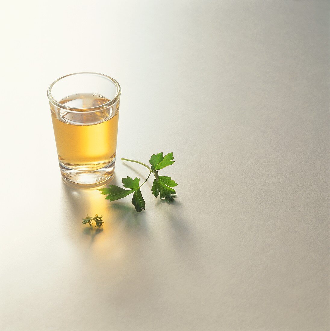 A glass of vinegar and parsley