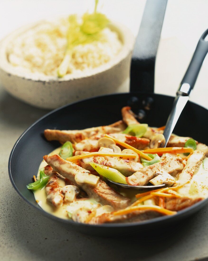 Finely chopped turkey with leeks and mushrooms in pan