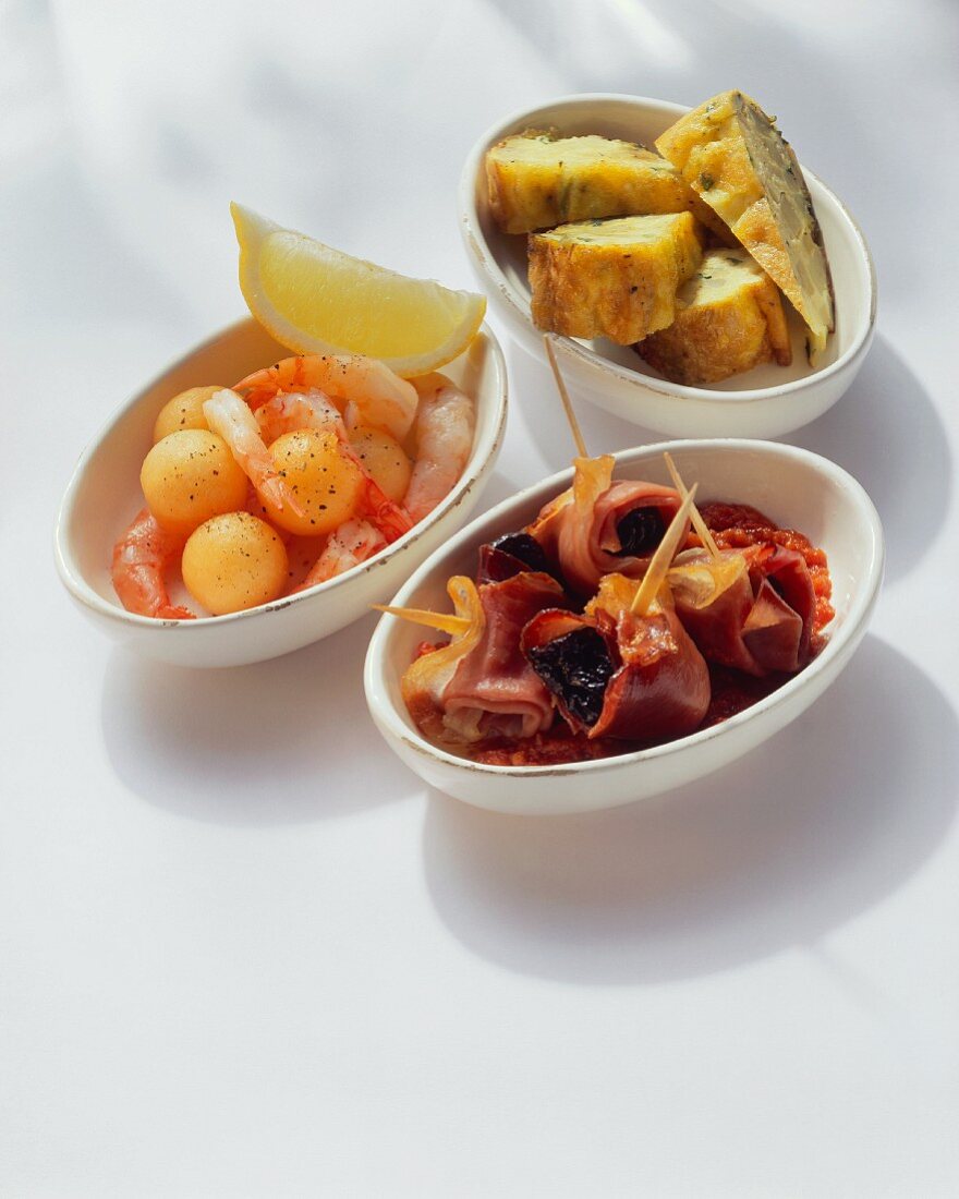 Three different tapas in white bowls