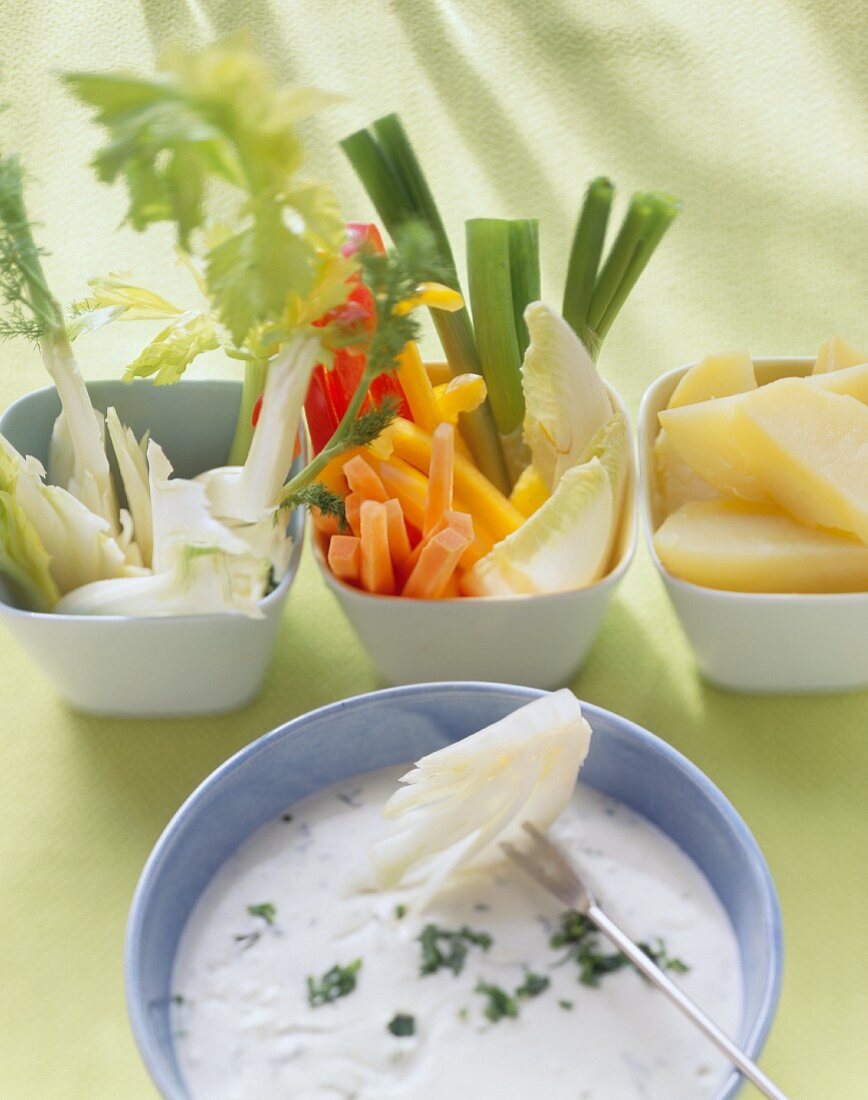 Cream cheese and herb fondue with vegetables and pears