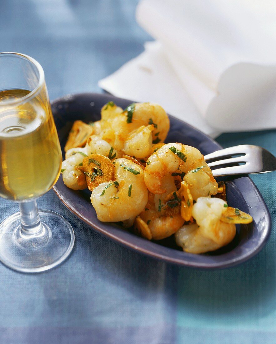 Shrimps in garlic with parsley; sherry glass