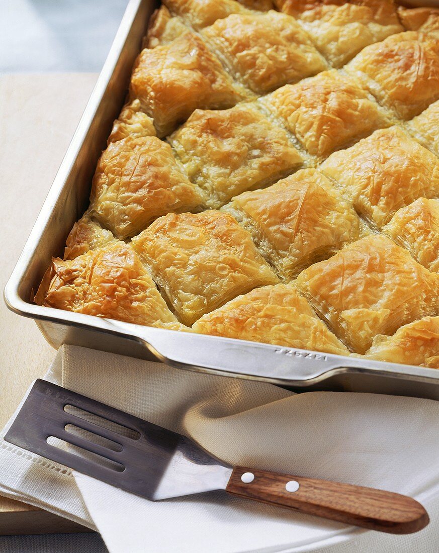 Puff pastry pie with spinach & sheep's cheese in baking dish