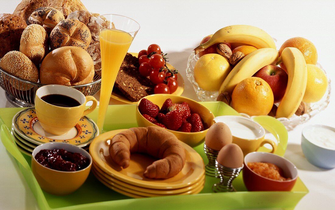 Breakfast with coffee, croissant, fruit, egg, orange juice