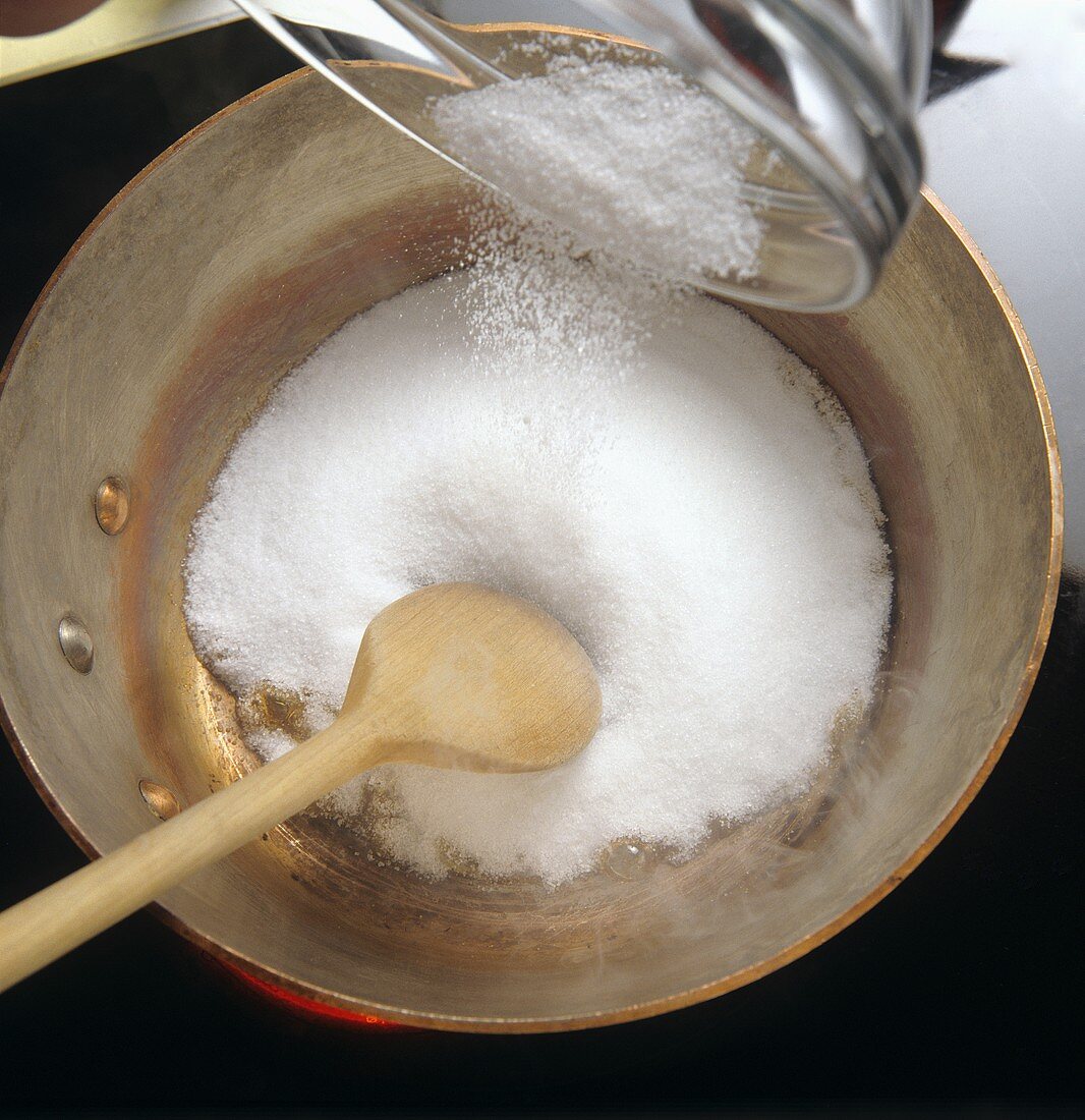 Tipping sugar into a bowl