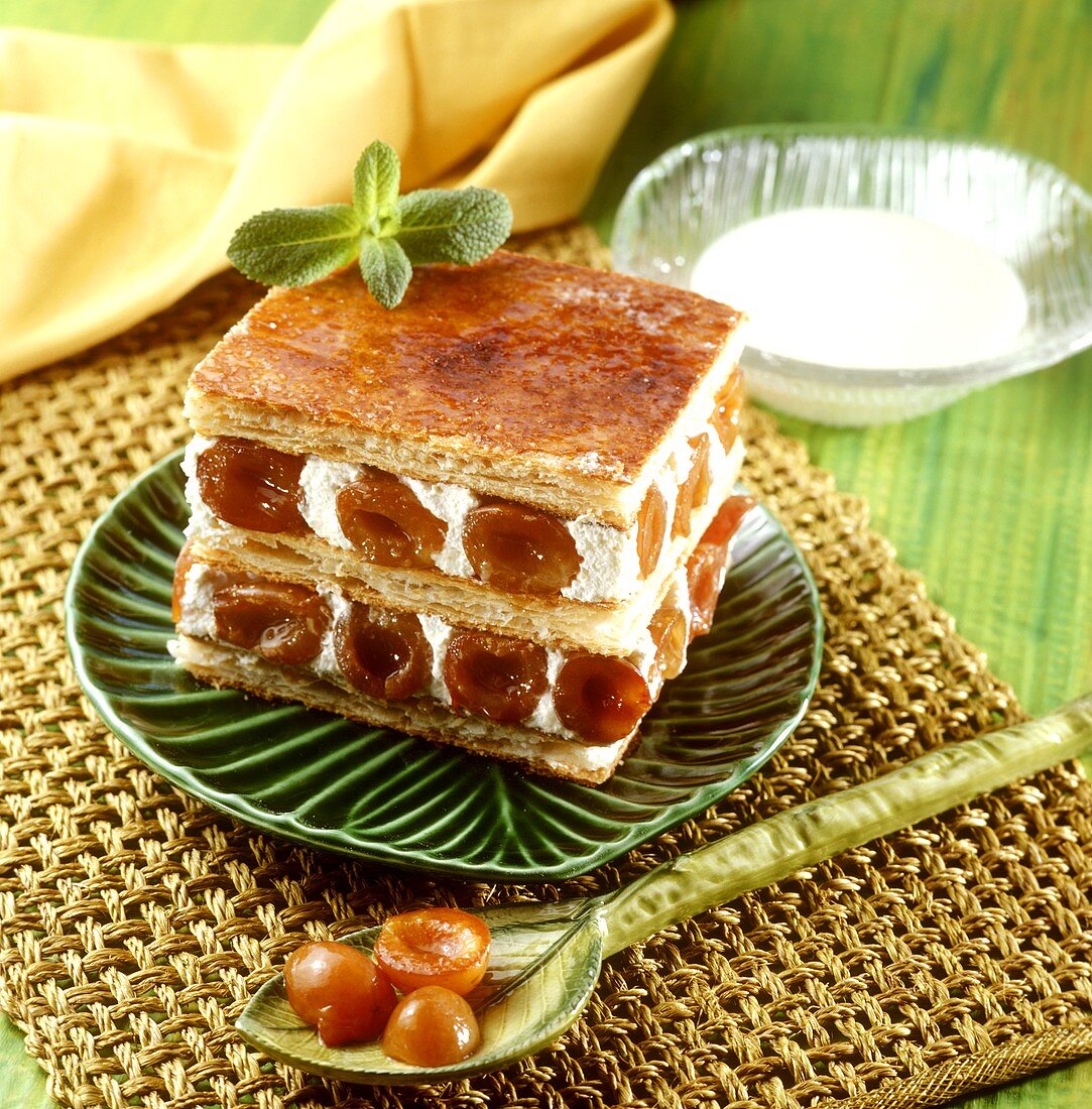 Piece of mirabelle cake on green plate