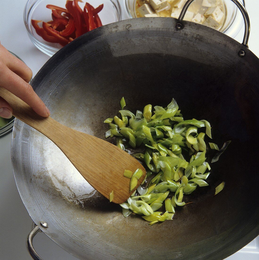 Frühlingszwiebeln im Wok anbraten