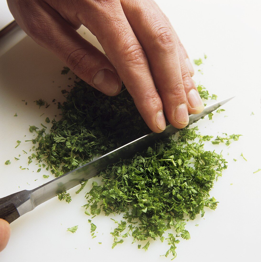 Finely chopping chervil with a knife
