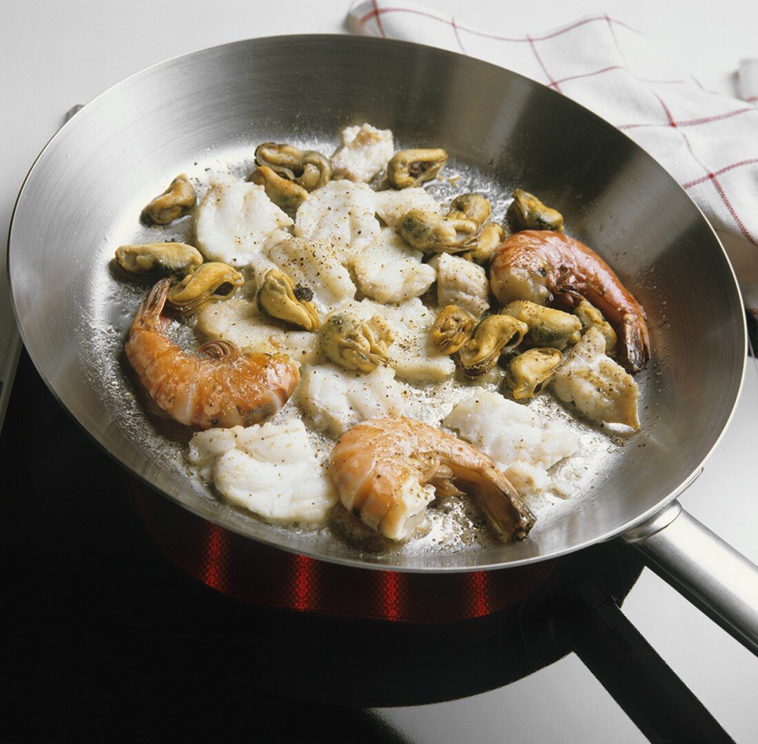 Frying seafood in a frying pan