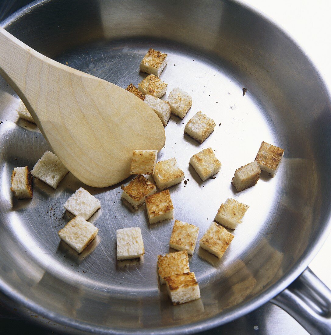 Frying croutons in a frying pan