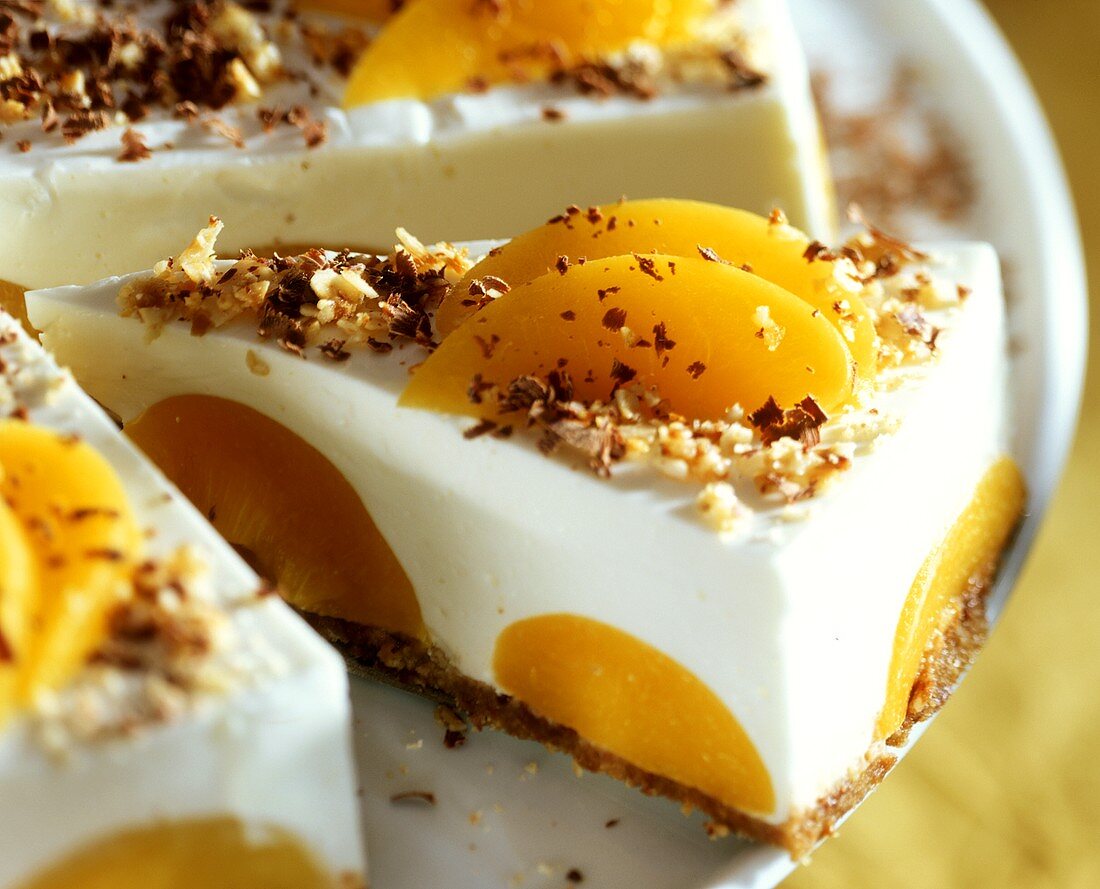 Peach gateau sprinkled with grated nuts