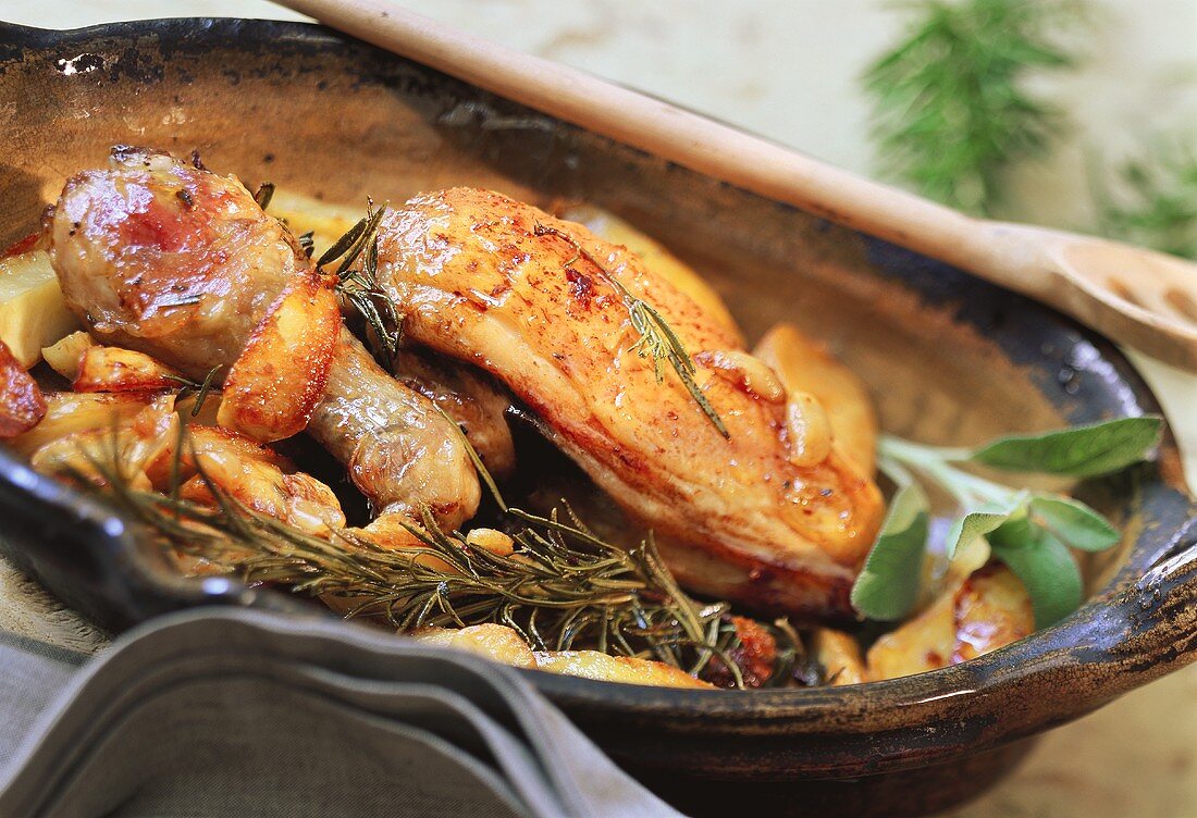 Roast chicken with potatoes, sage and rosemary