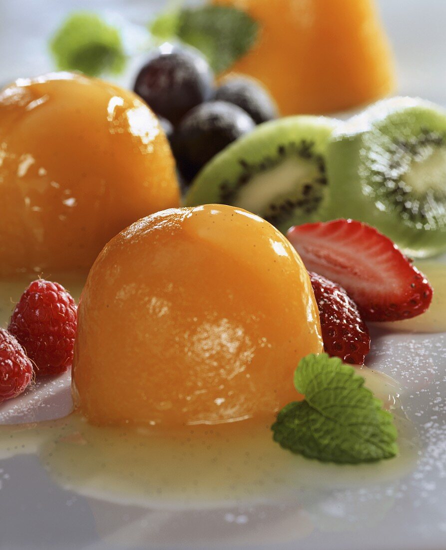 Peach jelly on Moscato sauce, garnished with fruit