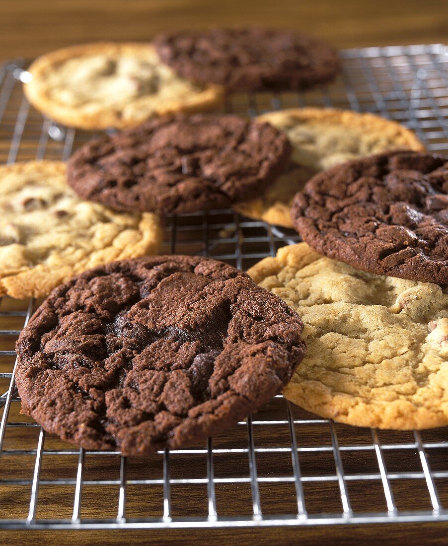 Light and dark chocolate biscuits on cake rack