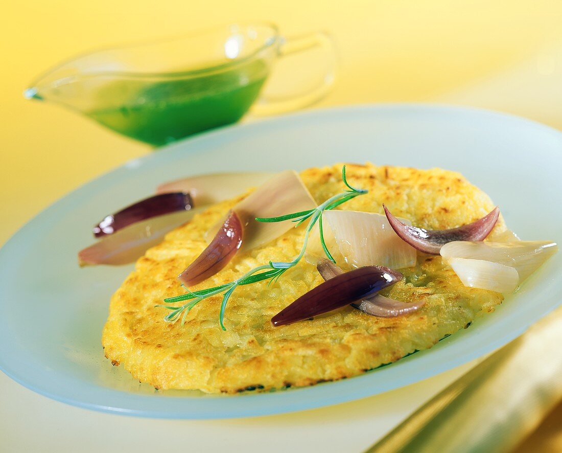 Rosti with shallots on plate; parsley sauce