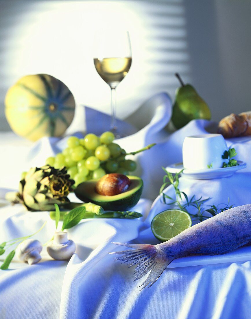 Stillleben mit Fisch, Gemüse, Obst, Käse und Weißwein