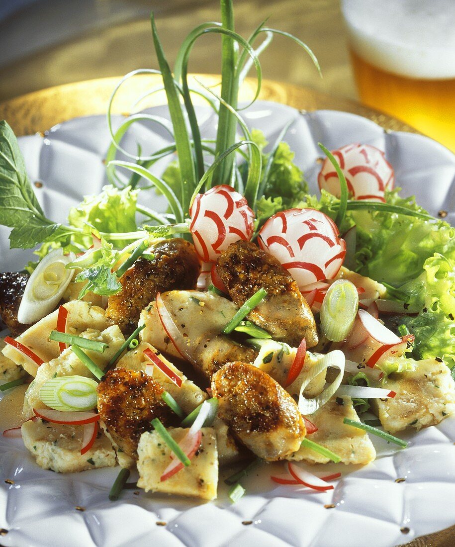 Dumpling salad with radishes, sausage and spring onions