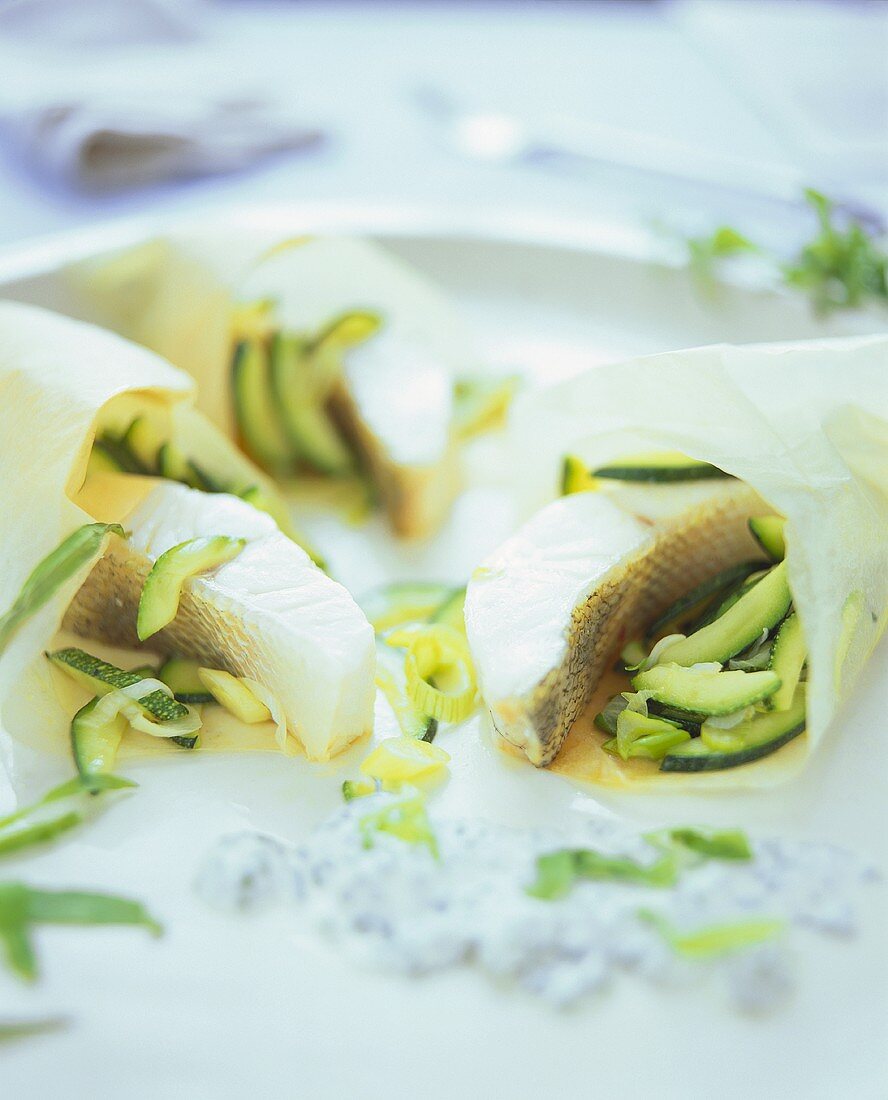 Fish parcels in greaseproof paper with courgettes