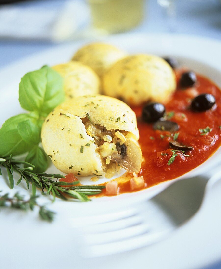 Pizza dumplings with mushroom filling in tomato sauce