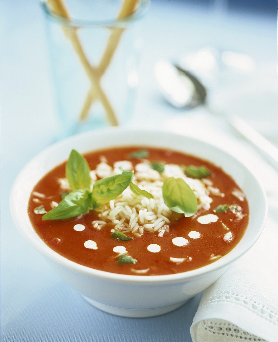 Tomato soup with rice and basil leaves