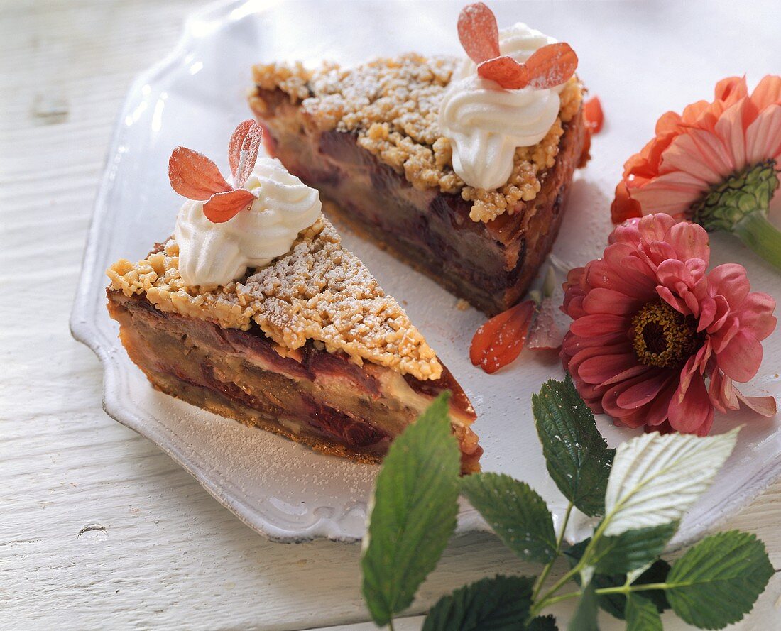 Plum and almond cake with cream and flower petals