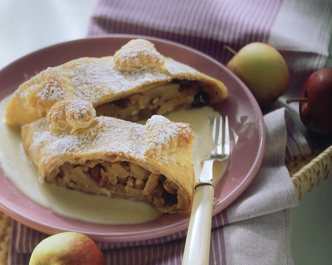 Apple strudel with nuts and icing sugar on plate