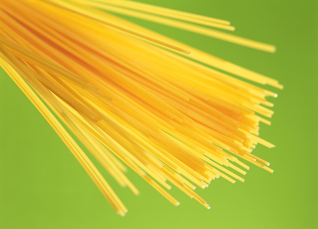 Spaghetti against green background