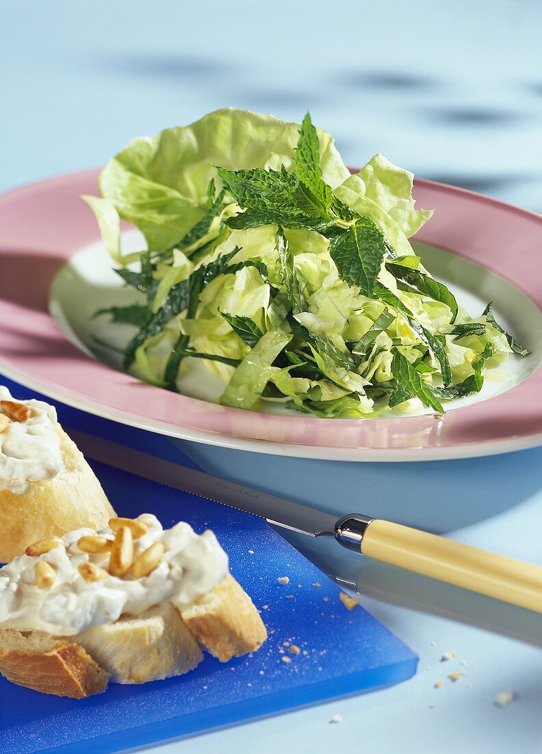 Mint salad and white bread with pine nut spread