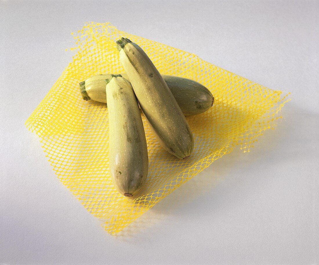 Courgettes on yellow net