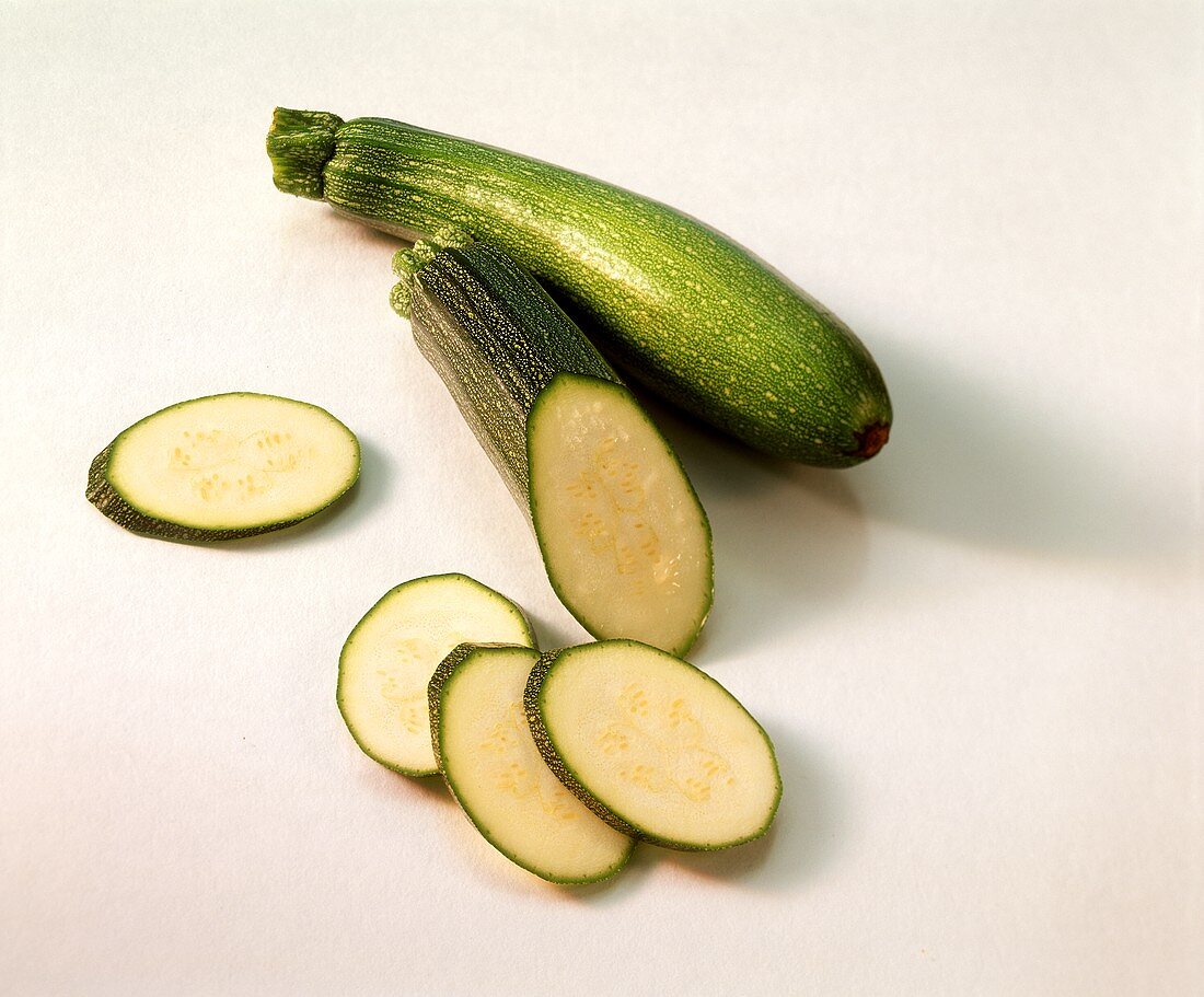 Courgettes, one with a piece cut off
