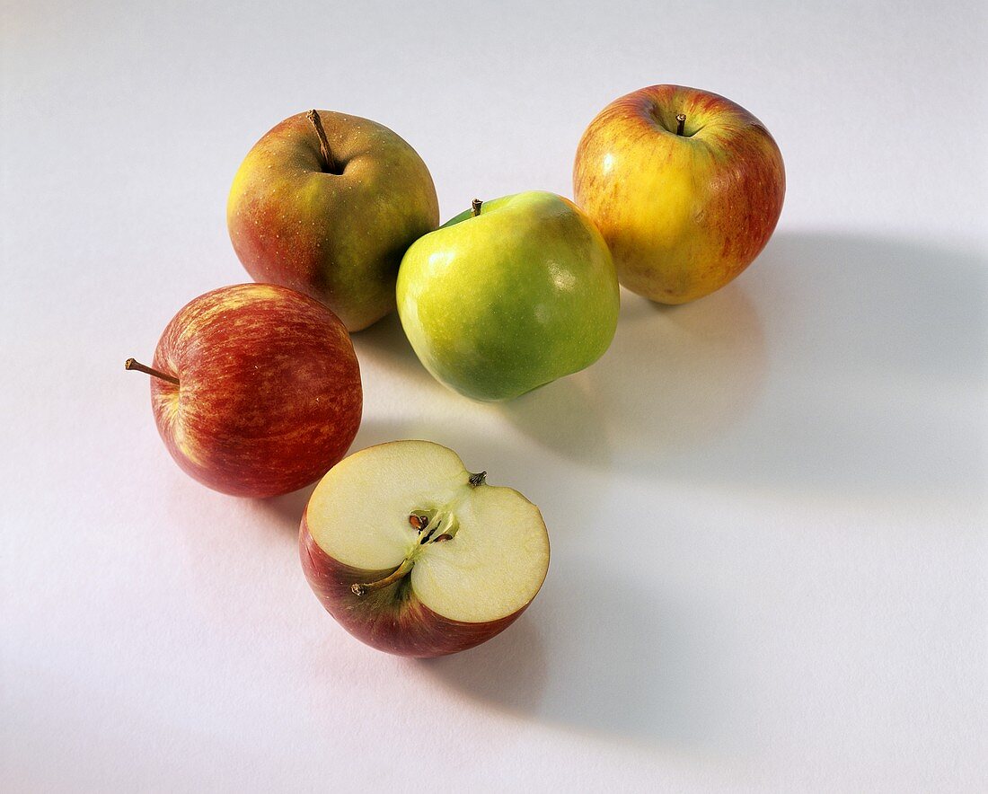 Various apples and half an apple