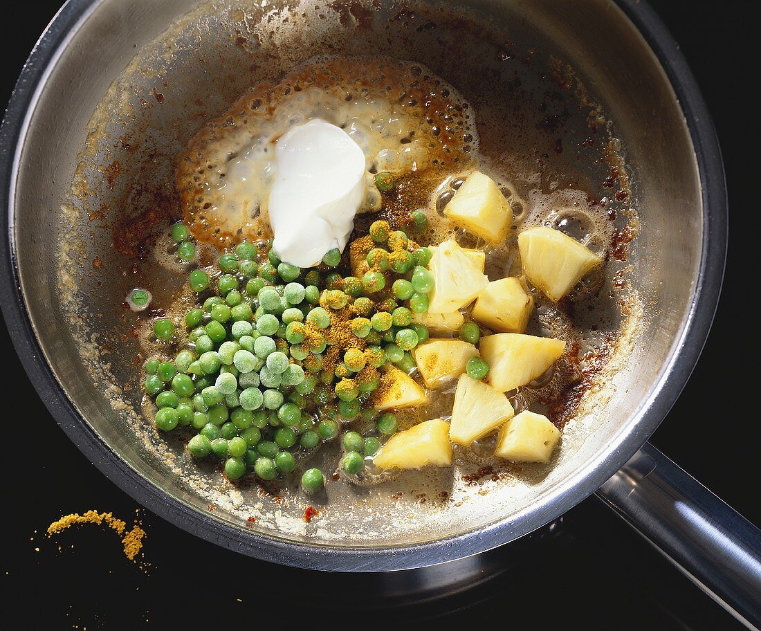 Sweating peas & pineapple with crème fraiche & curry powder