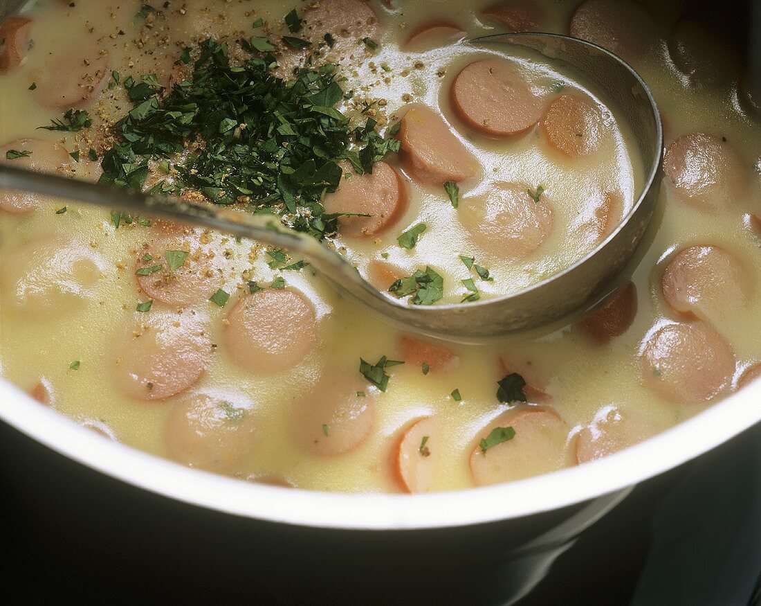 Seasoning potato soup with sausages