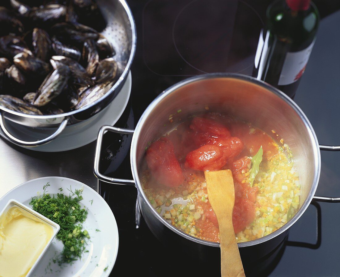 Preparing mussels: sweating diced vegetables and tomatoes