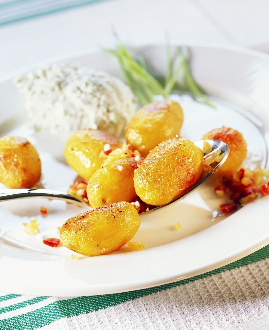 Whole fried potatoes with herb quark and diced bacon
