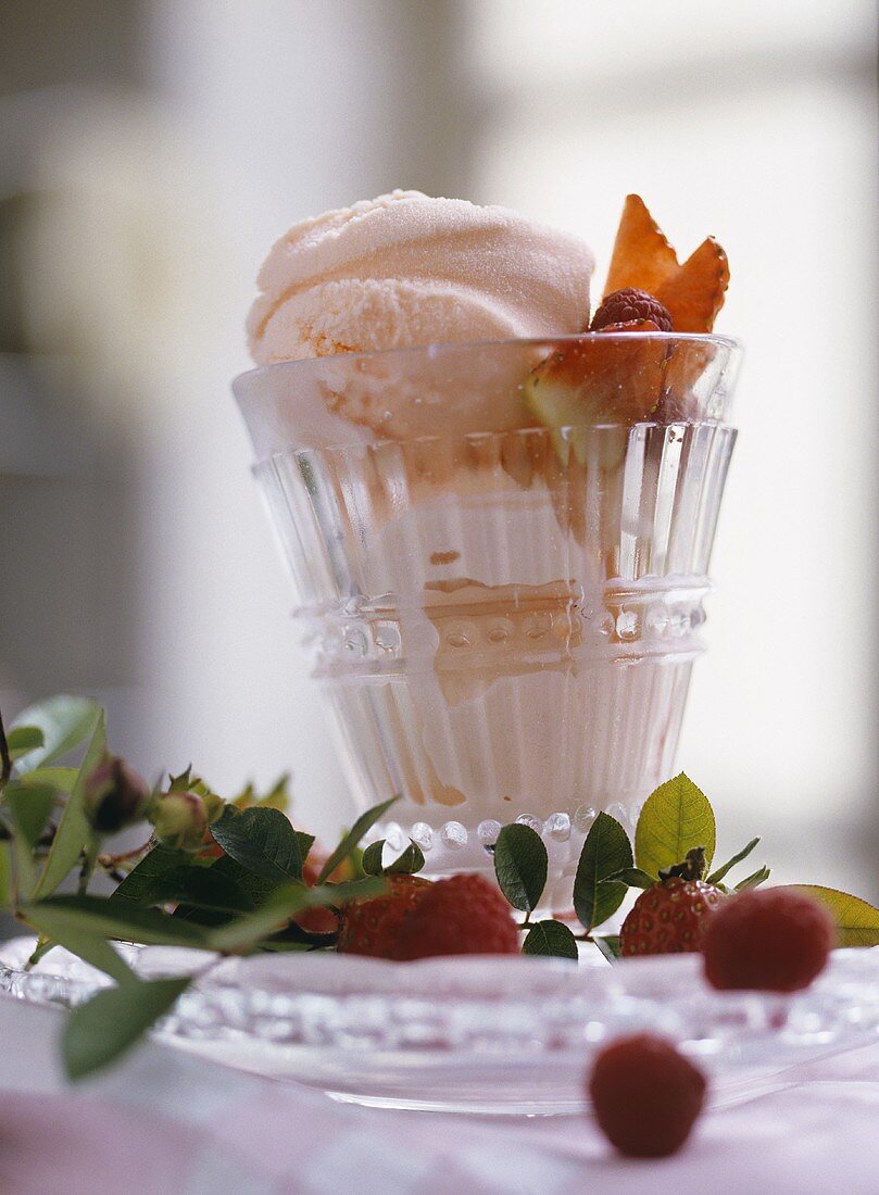 Rose ice cream with raspberries and strawberries in glass