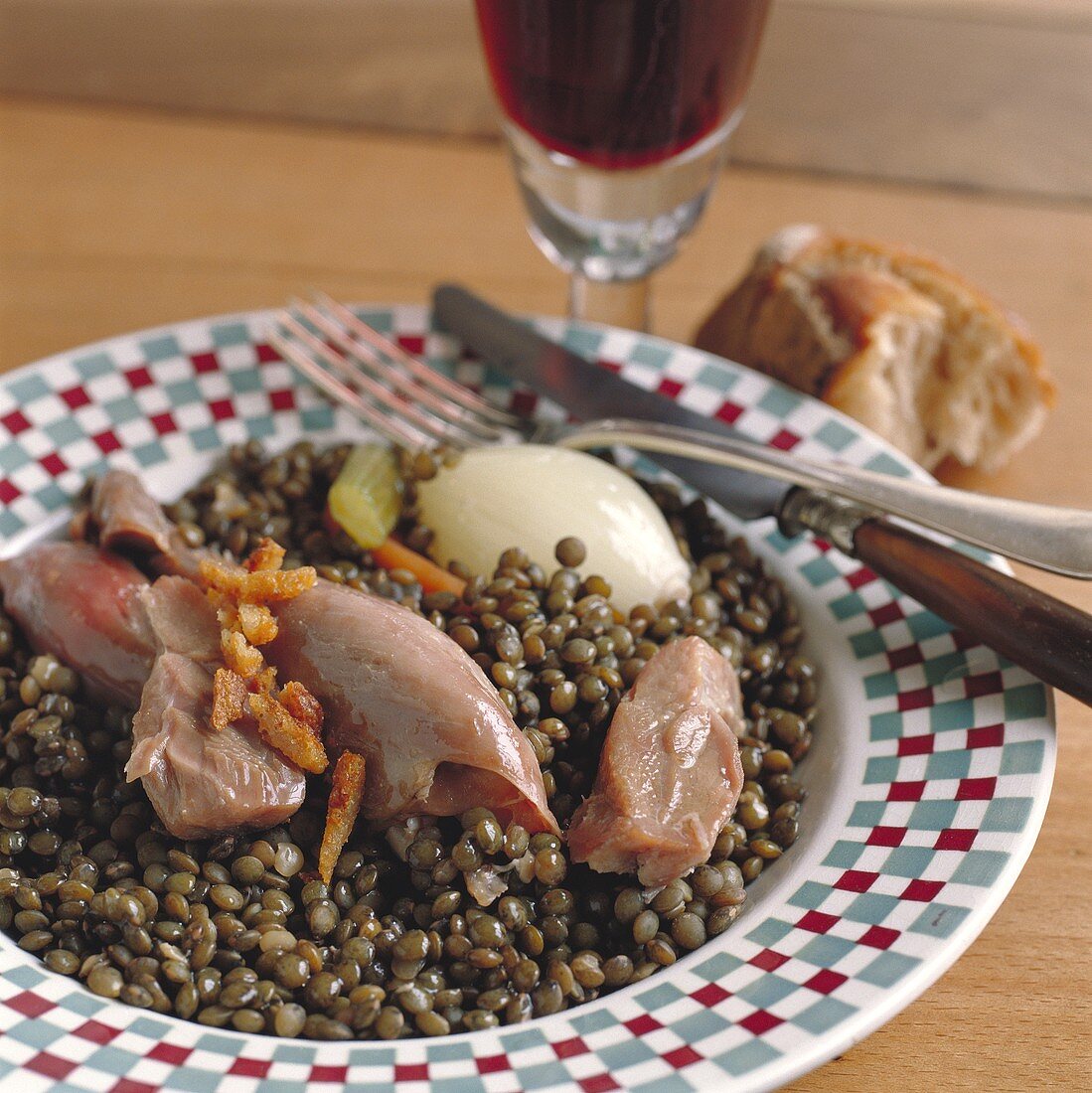 Duck and lentil stew with onion on plate