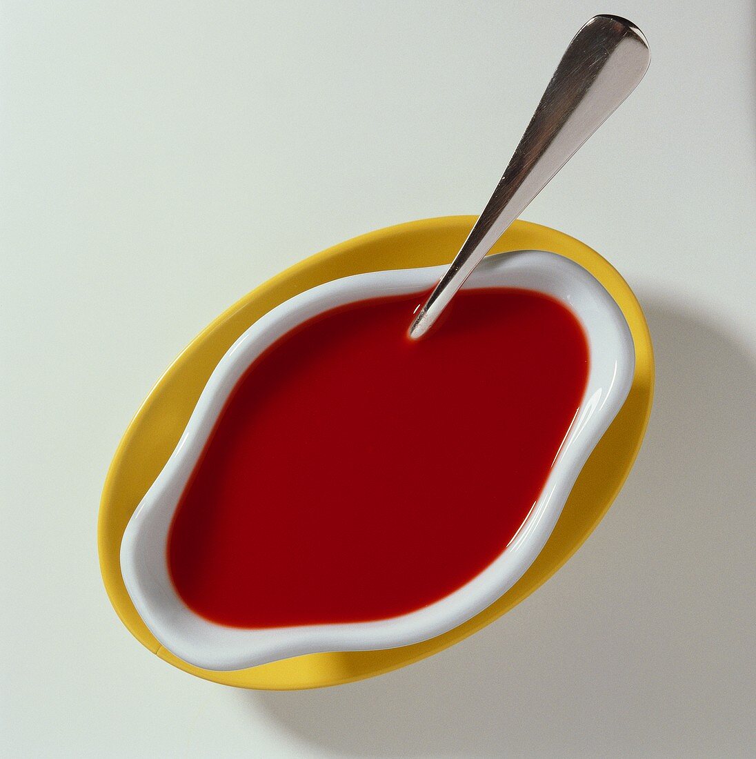 Tomato sauce in sauce boat with spoon